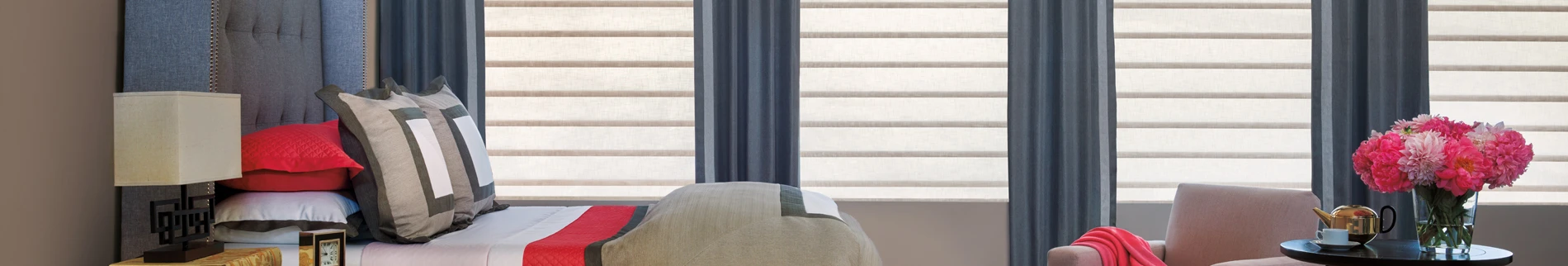 Hunter Douglas Window treatments with blue curtains.